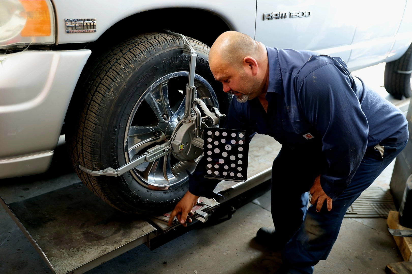 Technician performing wheel alignment
