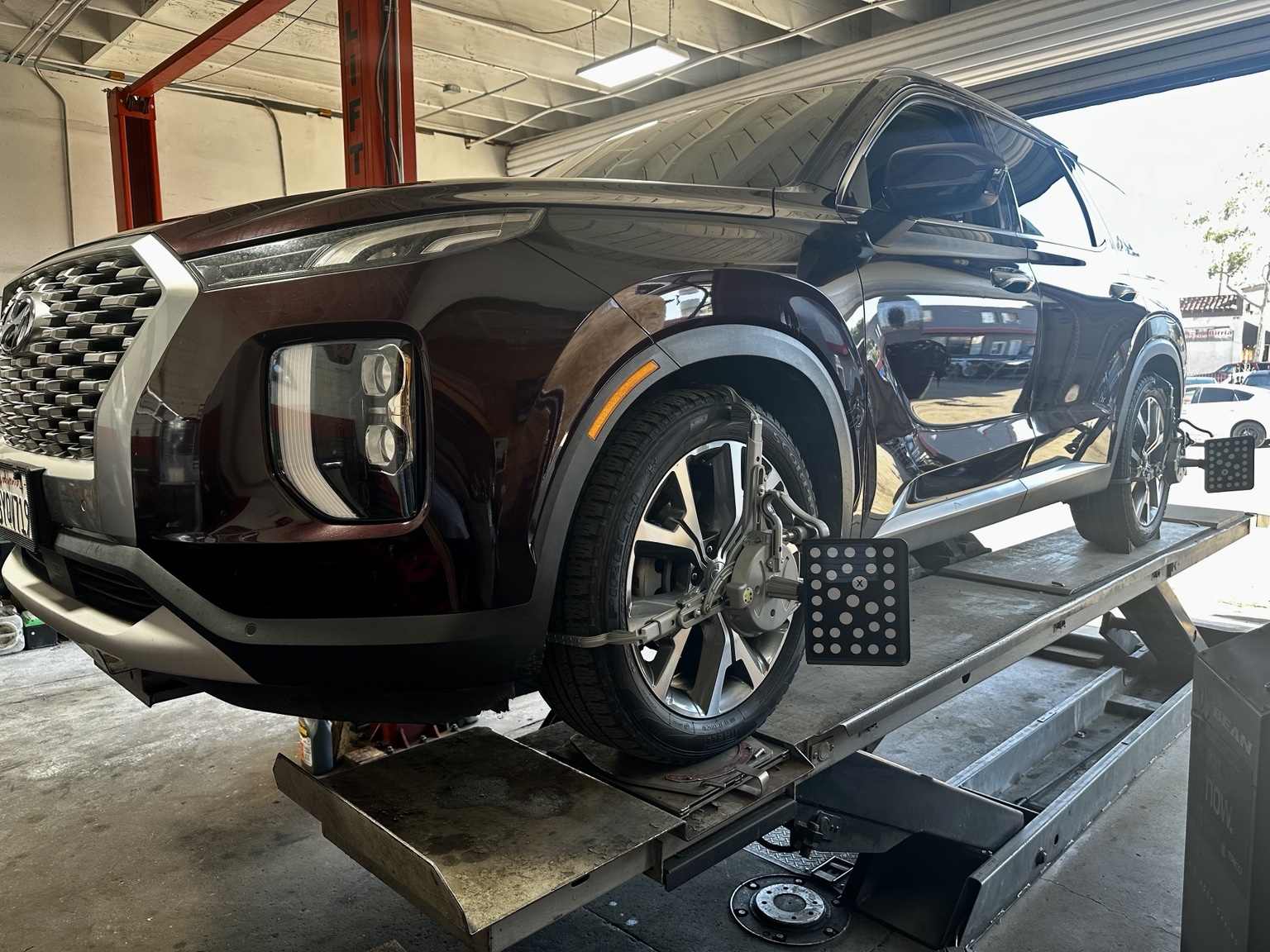 Vehicle on alignment rack at Vélez Auto Repair